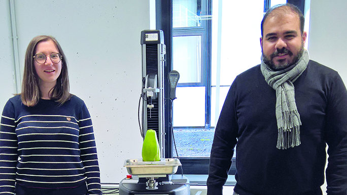 Project leader and young scientist in the lab in front of a device
